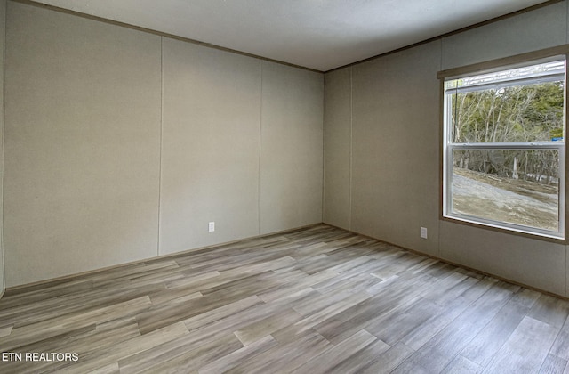 spare room featuring light wood-type flooring