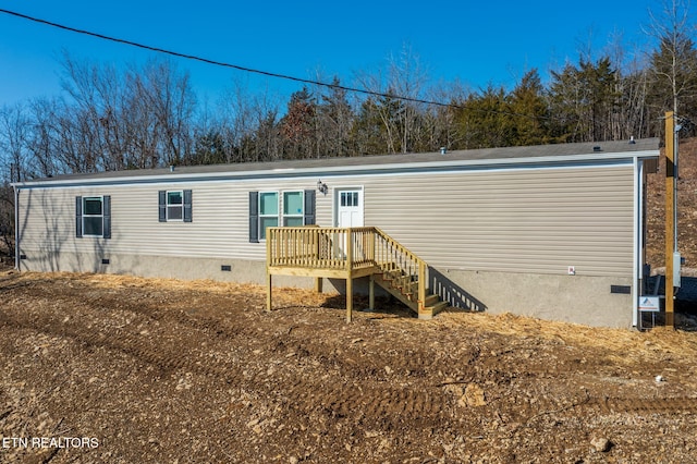 back of property with a wooden deck