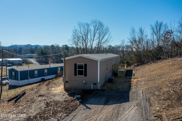 view of side of home featuring cooling unit