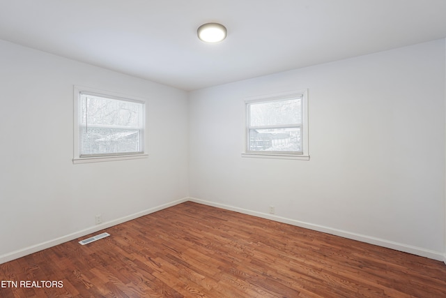 spare room featuring hardwood / wood-style flooring