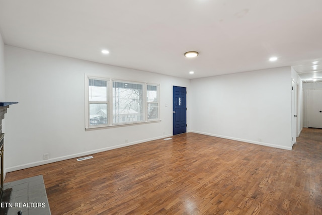 unfurnished living room featuring hardwood / wood-style floors