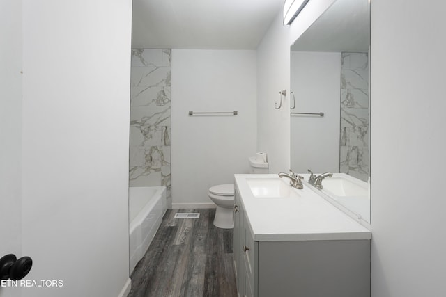 full bathroom featuring wood-type flooring, toilet, vanity, and  shower combination