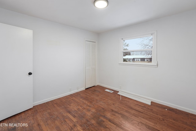 spare room with dark wood-type flooring