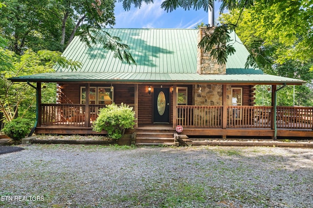 log home with covered porch