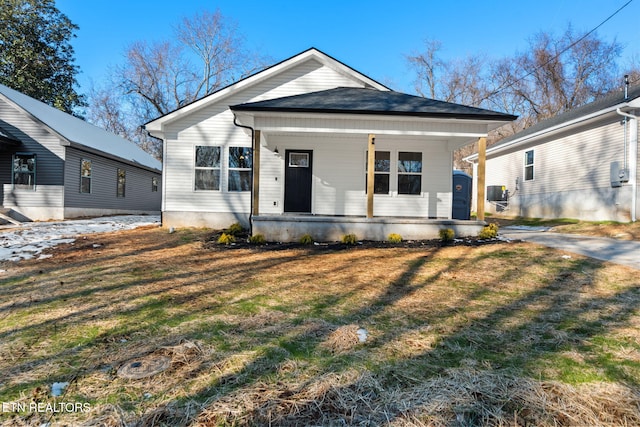 bungalow with a front lawn and covered porch