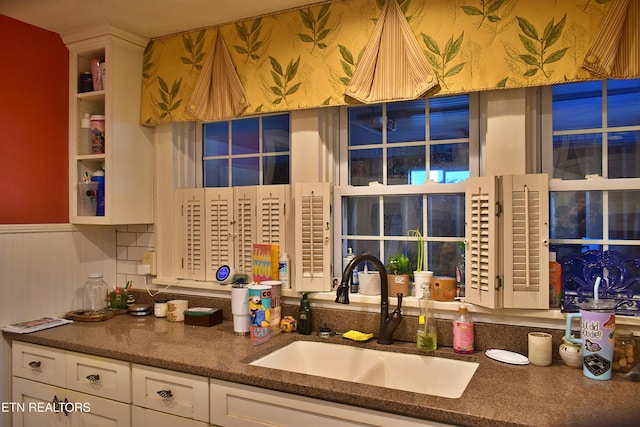 kitchen featuring sink and white cabinets