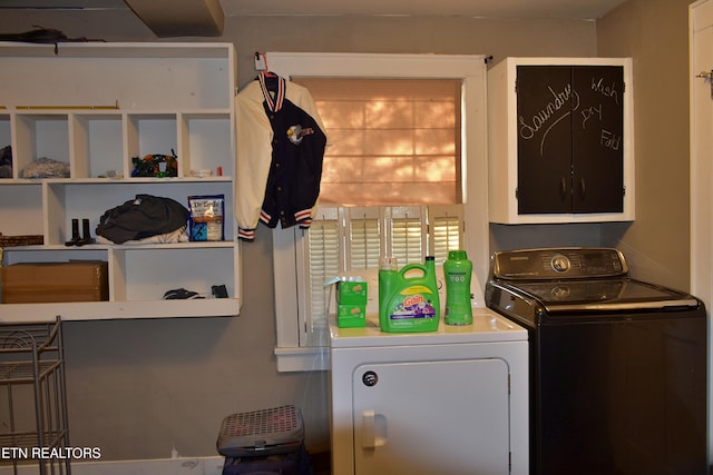 washroom with cabinets, washer and dryer, and a wealth of natural light