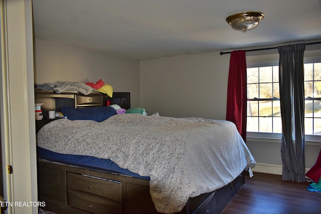 bedroom with dark hardwood / wood-style flooring