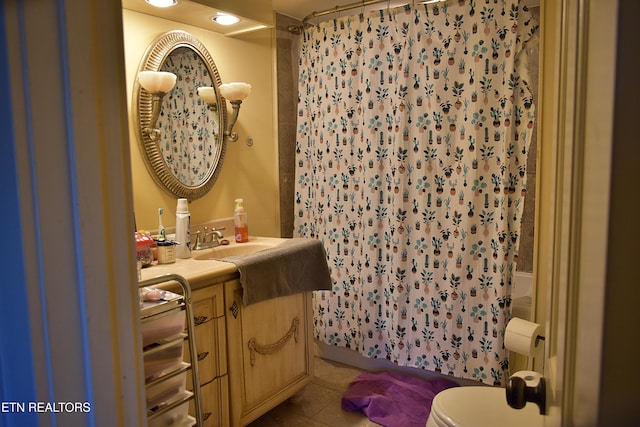 bathroom with a shower with curtain, toilet, tile patterned floors, and vanity