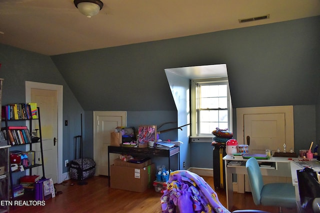 playroom with vaulted ceiling and wood-type flooring