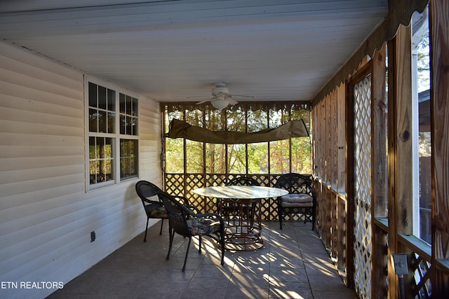 sunroom / solarium featuring ceiling fan