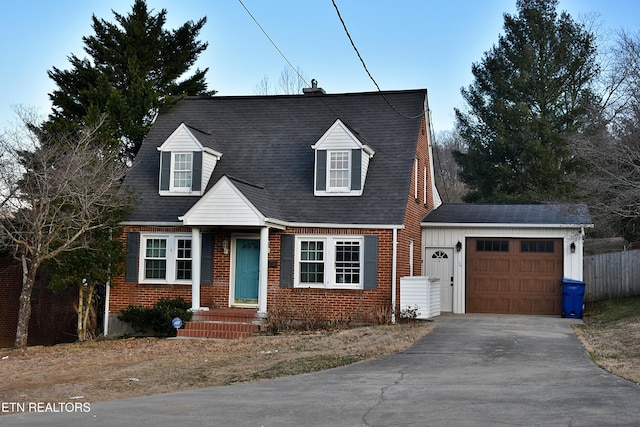 cape cod-style house with a garage