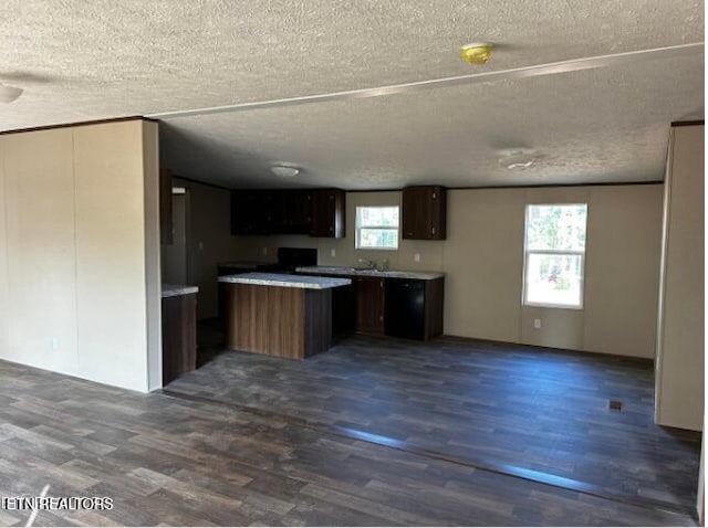 kitchen featuring dark hardwood / wood-style flooring, range, a textured ceiling, and dark brown cabinetry