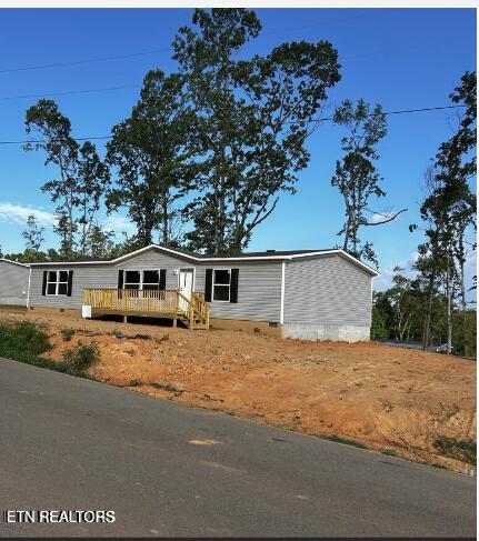 view of front of home featuring a wooden deck