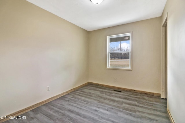 unfurnished room featuring hardwood / wood-style flooring