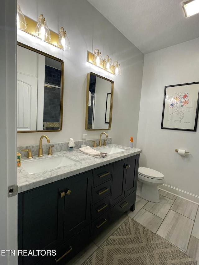 bathroom featuring toilet, vanity, and tile patterned flooring