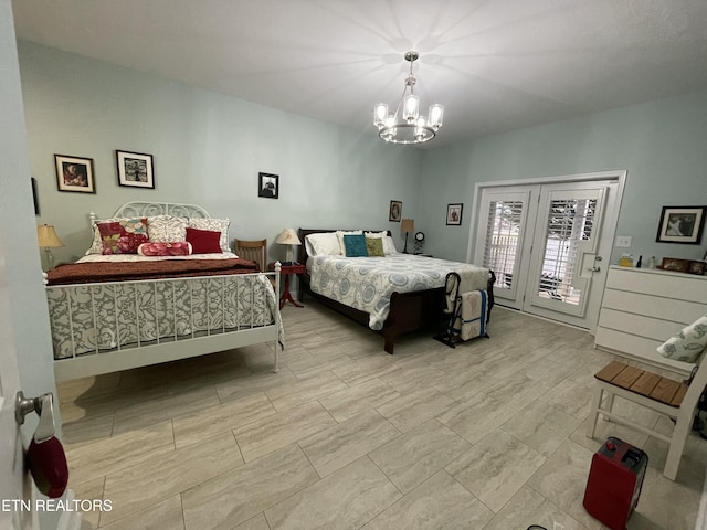 bedroom with access to outside and a notable chandelier