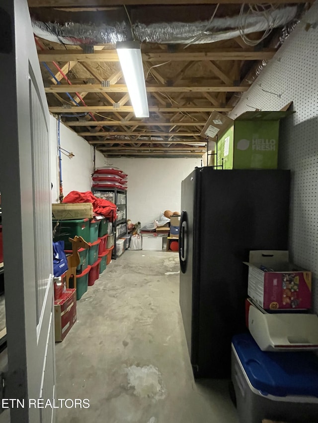 basement featuring black refrigerator