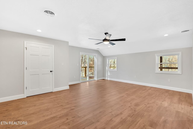 spare room with light wood-type flooring, ceiling fan, and lofted ceiling