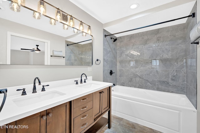 bathroom featuring ceiling fan, tiled shower / bath, and vanity