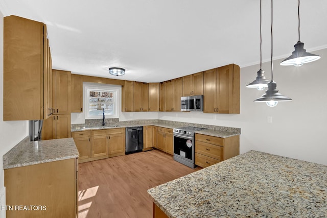 kitchen featuring light hardwood / wood-style floors, appliances with stainless steel finishes, hanging light fixtures, light stone counters, and sink