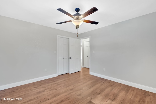 unfurnished room with ceiling fan and light wood-type flooring