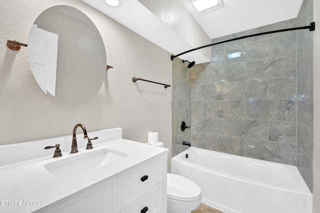 full bathroom with a textured ceiling, toilet, vanity, and tiled shower / bath combo