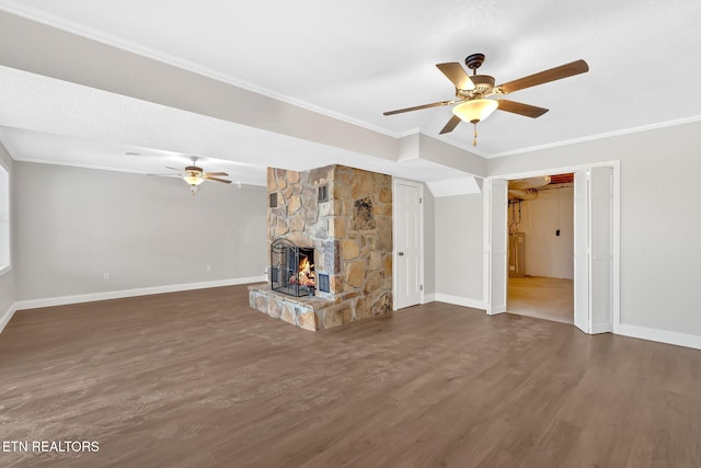 unfurnished living room with ceiling fan, dark hardwood / wood-style flooring, crown molding, and a fireplace