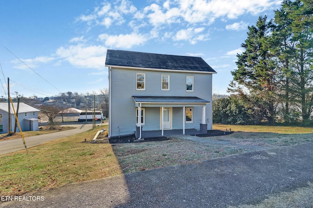 view of front of property with covered porch and a front lawn