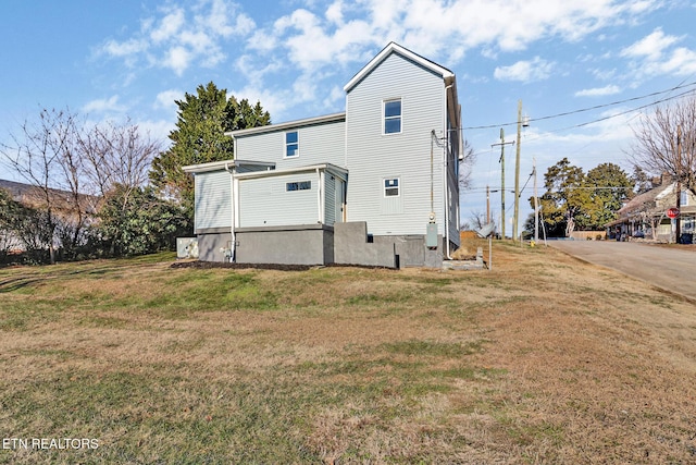 rear view of house featuring a yard