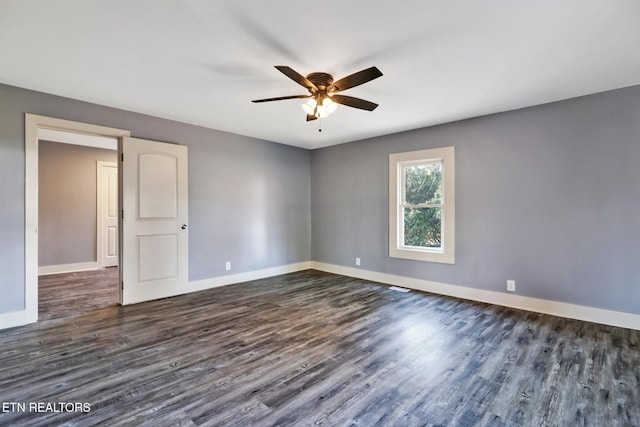 empty room featuring dark hardwood / wood-style floors and ceiling fan