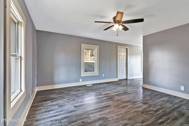 spare room featuring dark hardwood / wood-style floors and ceiling fan