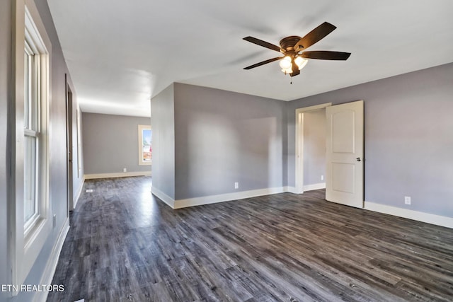 unfurnished room featuring dark wood-type flooring and ceiling fan