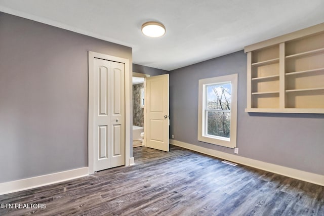 interior space featuring dark hardwood / wood-style flooring and a closet