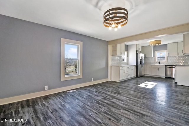 kitchen featuring gray cabinets, appliances with stainless steel finishes, sink, backsplash, and dark hardwood / wood-style flooring