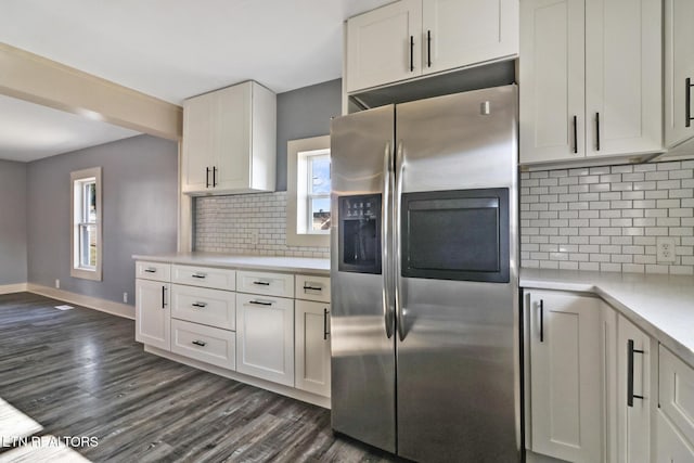 kitchen with white cabinetry, backsplash, stainless steel fridge, and a healthy amount of sunlight