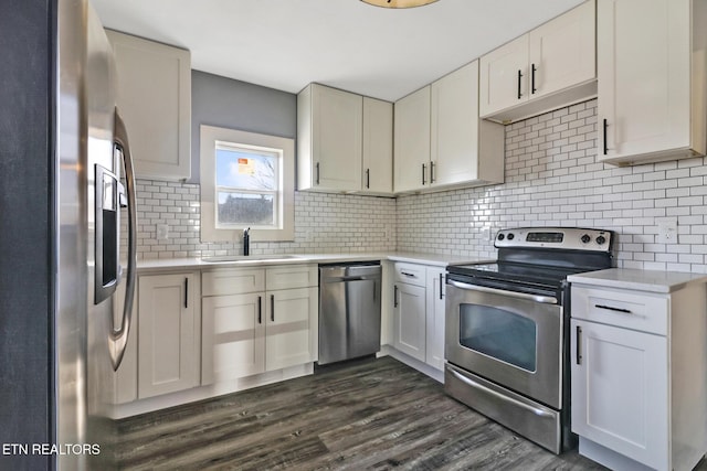 kitchen featuring white cabinetry, sink, decorative backsplash, and stainless steel appliances