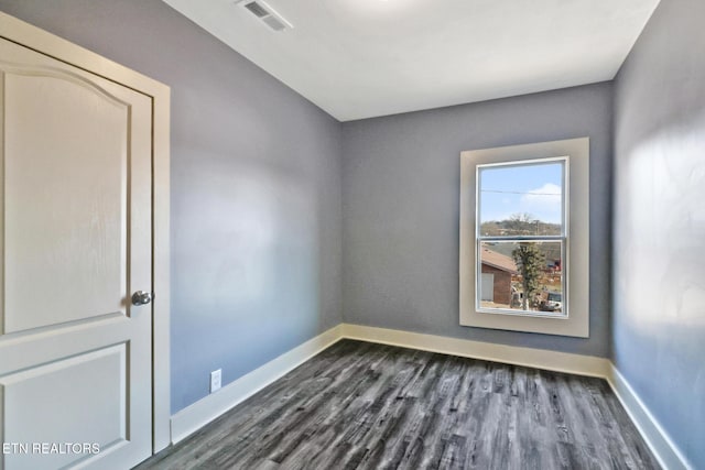 unfurnished room featuring dark hardwood / wood-style floors