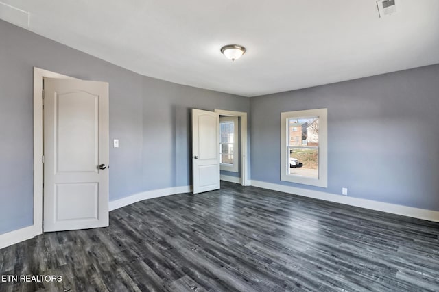 empty room featuring dark wood-type flooring