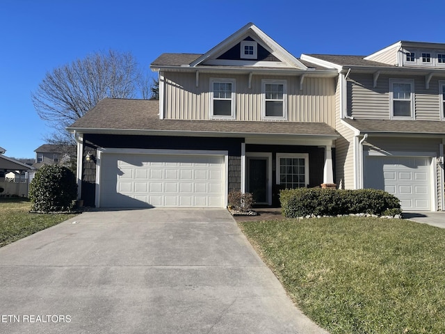 townhome / multi-family property featuring a front lawn and a garage