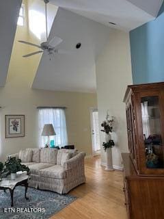 living room with high vaulted ceiling, light wood-type flooring, and ceiling fan