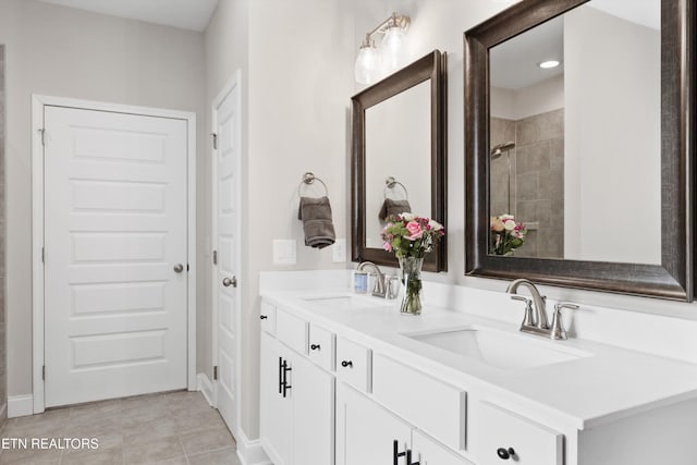 bathroom with tile patterned floors, a sink, and double vanity