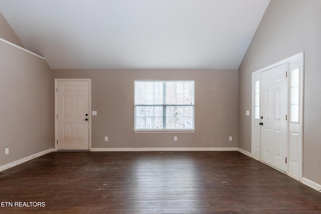 entrance foyer with dark hardwood / wood-style flooring and lofted ceiling