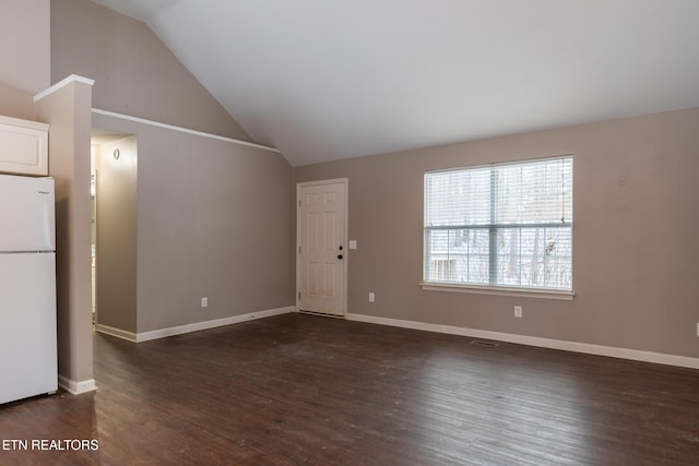 unfurnished living room with dark wood-type flooring and vaulted ceiling