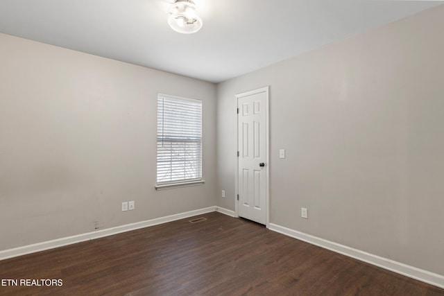 unfurnished room featuring dark hardwood / wood-style floors