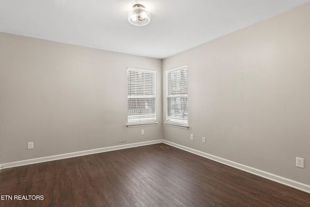 spare room with dark hardwood / wood-style flooring