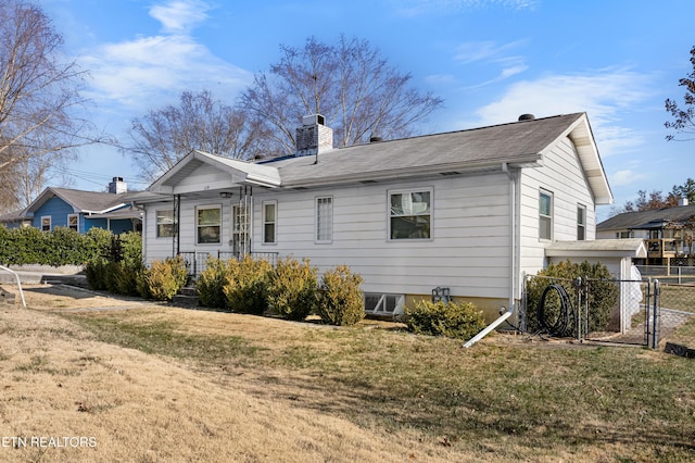 back of house with a lawn