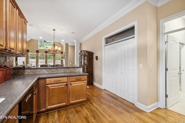 kitchen with ornate columns, an inviting chandelier, decorative backsplash, kitchen peninsula, and light hardwood / wood-style flooring