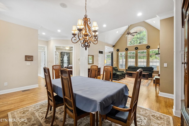 dining space with ceiling fan, lofted ceiling, light hardwood / wood-style flooring, and crown molding