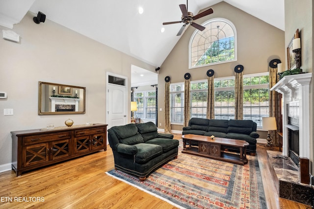 living room with high vaulted ceiling, light hardwood / wood-style flooring, and ceiling fan